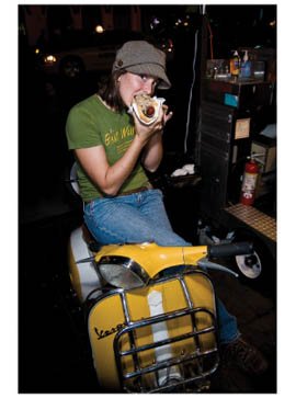 cute girl eating a bratwurst